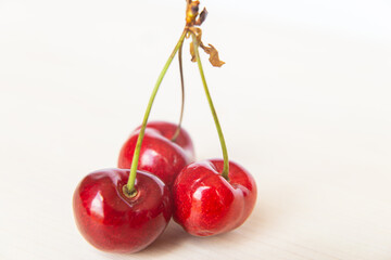 Ripe cherries on wooden surface