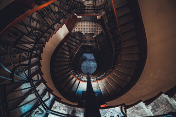 Destroyed spiral staircase indoors. Natural light. Beautiful architecture. Old apartment building...