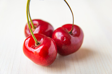 Ripe cherries on wooden surface