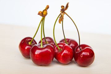 Ripe cherries on wooden surface