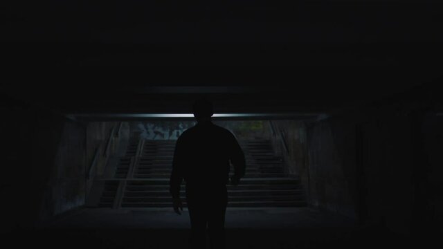man walks in the evening city underpass
