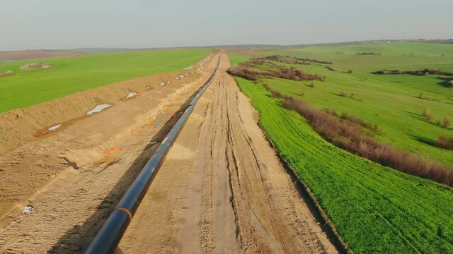 Drone flight Above Gas and Oil Pipeline. Pipes welded together, are laid on top of supportive sandbags beside the trench line. Turkish Balkanian Stream to Europe with Russian gas.