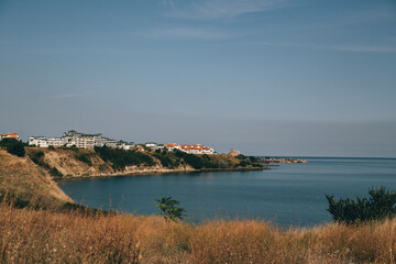 Fototapeta na wymiar sea shore beach coast and sunny city at the skyline 
