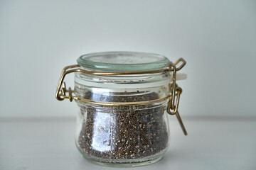  Glass jars with a lid for food on a white shelf. Storage in the kitchen. Containers with bulk products. Transparent container.