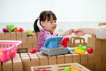 toddler girl pretend play shop keeper at home