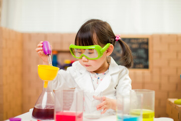 toddler girl pretend play scientist role for homeschooling