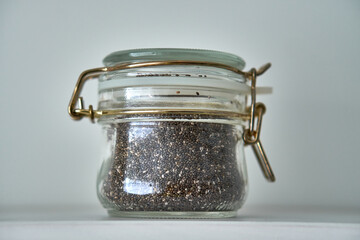  Glass jars with a lid for food on a white shelf. Storage in the kitchen. Containers with bulk products. Transparent container.