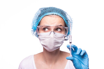 woman in medical mask wearing glasses and gloves is holding a syringe