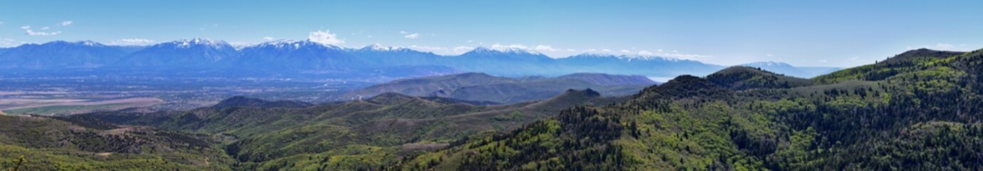 Fototapeta premium Rocky Mountain Wasatch Front peaks, panorama landscape view from Butterfield Canyon Oquirrh range by Rio Tinto Bingham Copper Mine, Great Salt Lake Valley in fall. Utah, United States.
