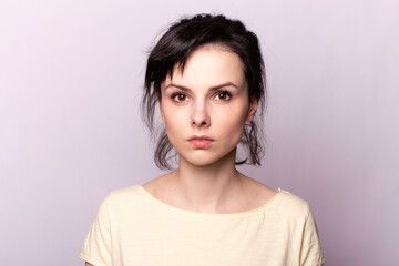 Fototapeta premium young girl in a yellow t-shirt on a gray background
