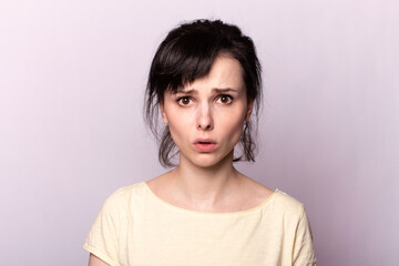young girl in a yellow t-shirt on a gray background