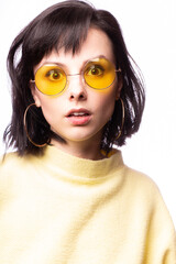 beautiful girl in yellow glasses and a yellow sweater