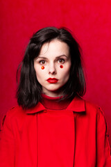 girl in red clothes with red lipstick on her lips, red background