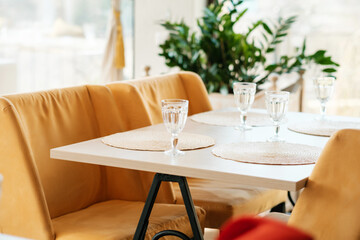 Empty wine glasses  in an empty cafe during pandemic. No guests. Served table.