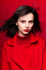 white-skinned woman dressed in red, red background, monochrome