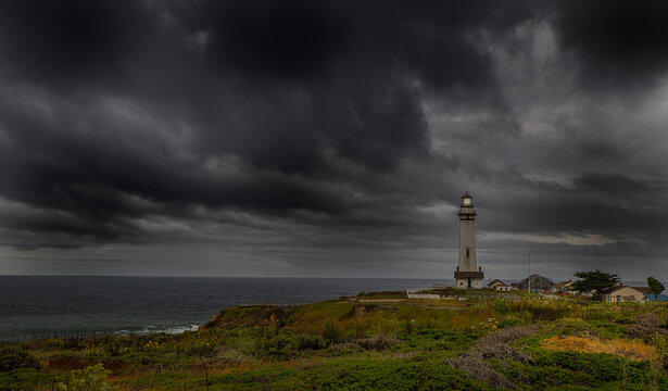 Pigeon Point Lighthouse with a very ominous dark cloud coming in from the Pacific ocean