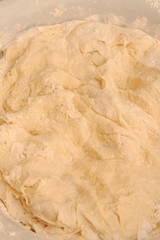 Raw dough mixed in a bowl for making homemade dumplings