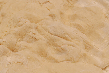Raw dough mixed in a bowl for making homemade dumplings
