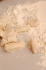 Sliced raw dough into pieces prepared for cooking homemade dumplings