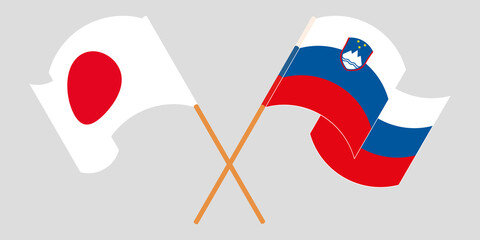 Crossed and waving flags of Slovenia and Japan