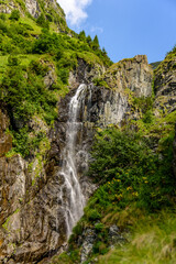Fototapeta na wymiar Beautiful waterfall on a summer day from Fagaras Mountains, Romania