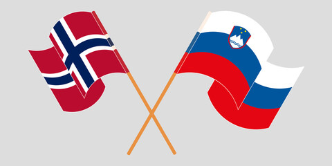Crossed and waving flags of Slovenia and Norway