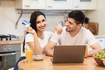 Happy family holding credit card for shopping online