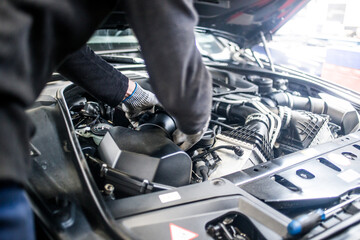 Mechanic fixing car engine

