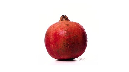 Ripe red pomegranate in drops of water rotates on white background isolate. Beautiful exotic berry. Fruit pomegranate contains a lot of vitamins and is antioxidant for healthy and strong people.