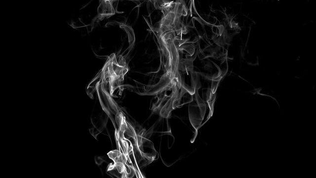 Atmospheric smoke 4K Fog effect. VFX Element. Haze background. Abstract smoke cloud. Smoke in slow motion on black background. White smoke slowly floating through space against black background.