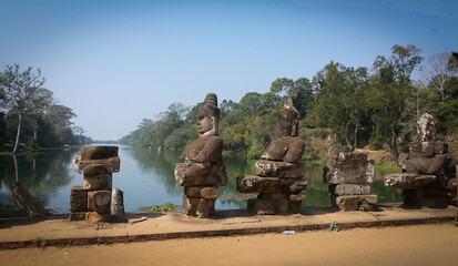Statue of guardians in the bridge in Angkor Wat, cambodia, sunny day