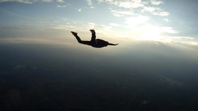 Skydiving student doing stunts in free fall.