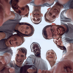 bottom view. a group of successful young people pointing at you