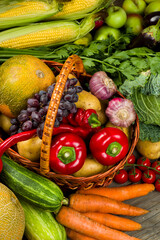 wicker grocery basket with agricultural vegetables from the grocery market, place for text