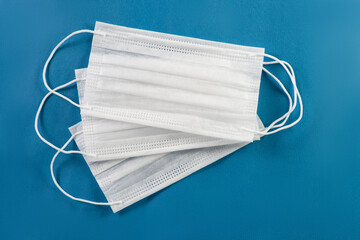 Three face masks on a blue background