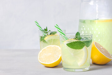 Lemon lemonade with herb on grey background.