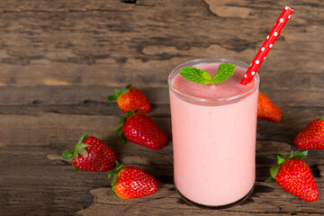 Strawberry yogurt fruit juice smoothie pink colorful fruit juice milkshake blend beverage healthy high protein the taste yummy In glass drink episode morning on wood background.