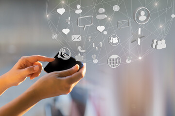 businessman holding smart phone with social network icons	