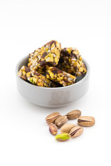 Fruit, nut and seed bar with pistachios isolated on white.