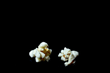 two popcorn on black background