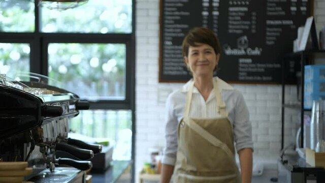 Business concept. The shopkeeper is posing with confidence in the coffee shop. 4k Resolution.