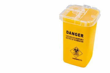 Yellow container for contaminated needles to be destroyed by isolated incineration on a white...