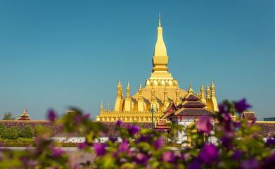 Naklejka premium Golden Pagoda in Vientiane, Laos. Pha That Luang at Vientiane. Blue sky background beautiful.