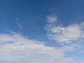 white clouds against a blue sky background