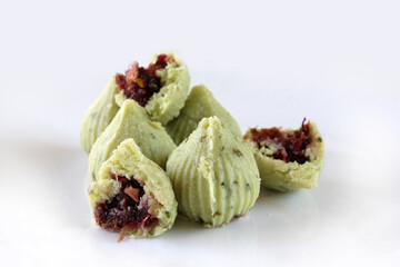 Modak [ladoo]or ladu is Indian traditional sweet dish made from khoya[mawa] with sugar and dryfruits during festival of lord Ganesha.