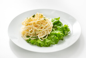 Noodles, italian pasta on lettuce in a plate on the table. Isolate

