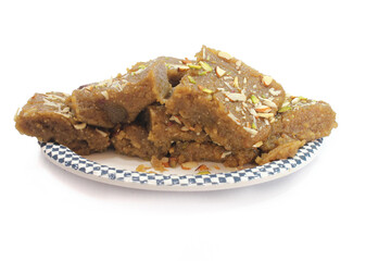Indian Traditional sweet Lapsior shira or Halwa made from broken wheat,jaggery and desi gheeand garnished with nuts.selective focus.