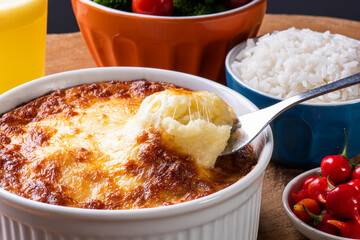 Escondidinho. Typical Brazilian food. Made from potatoes and chicken. .Accompanied by rice and salad