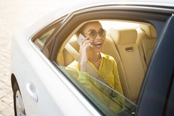 Young Lady Talking On Cellphone Sitting In Car During Ride