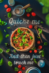 Quiche me lettering with basol. mozarella, ant tomatoes quiche, creative food flat lay
